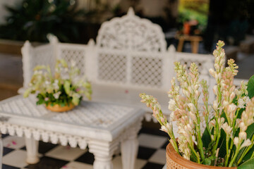 Elegant Floral Arrangement on Intricately Carved White Furniture for Sophisticated Events and Interior Design Projects, a Touch of Luxury,