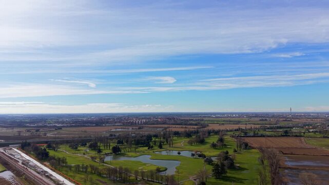 Aerial view of golf course landscape with beautiful blue sky and clouds