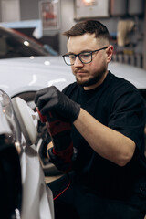 Man polishing car with orbital applicator