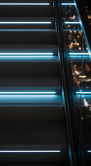 Obraz premium Close-up of a stairway with blue light, creating a modern, illuminated appearance, representing guidance, transition, and a path toward advancement