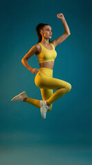 Dynamic Leap of Wellness: A woman, embodying vitality and dedication, soars through the air, showcasing a peak state of physical fitness and focused determination.