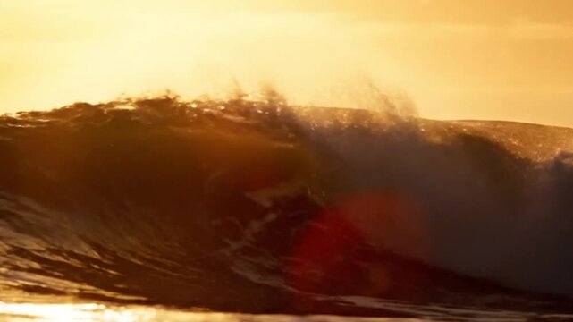 Golden sunset over a curling ocean wave at the shore, dramatic coastal landscape.