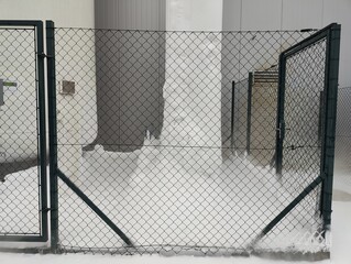 Snowy Industrial Fence Gate with Snowdrifts