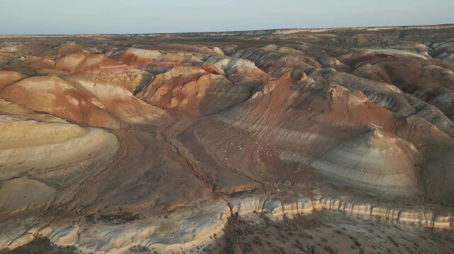 Aerial view of Aktumsuk cliffs and hills in Uzbekistan, where Aral Sea once touched the summits. Now this drone view captures an almost Martian landscape, rich in colors