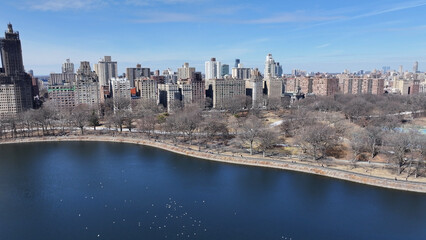 Obraz premium Central Park In Manhattan New York United States. Aerial View Of Green Space Surrounded By Lush Forest Trees. Industrial Skyline Skyscrapers Amazing. Industrial Cityscape. Manhattan New York.