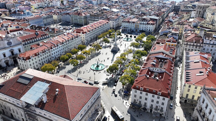 Obraz premium Dom Pedro Iv Square In Lisbon Portugal. Modern City Center With Skyscrapers Reflecting The Urban Life. Metropolitan Landscape High Rise Building Amazing. Metropolitan Town. Lisbon Portugal.