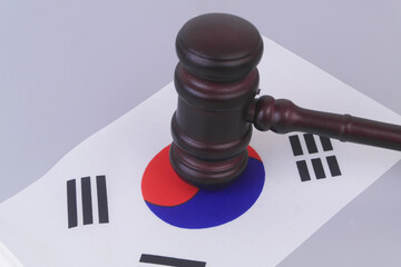 Judge gavel on flag of South Korea. Laws and court in Korea.