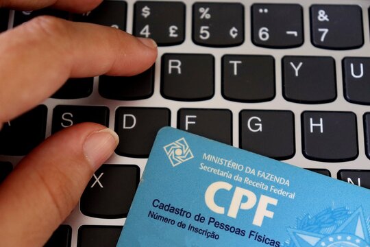 Salvador, Brazil - February 7, 2026: Brazilian CPF (Cadastro de Pessoa Fisica) identification card. Personal identification in Brazil. CPF card on a laptop keyboard. 