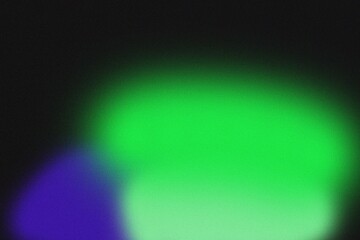 Gradient light spot illuminates dark space with vibrant green and blue hues from a close-up viewpoint