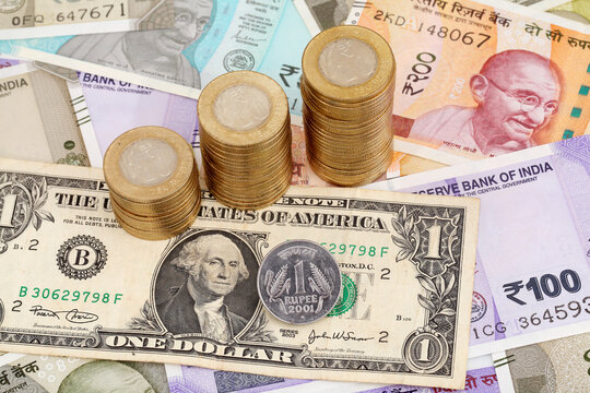 Stack of coins and Indian rupee coin in Indian currency notes 