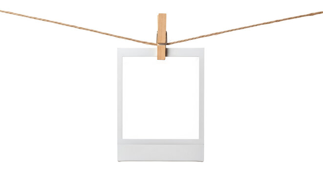 Blank instant photo frame PNG isolated on transparent background, hanging from a jute string with a wooden clothespin, retro style