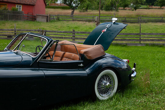 Jaguar XK 140 SE DHC from 1955 with open roof photographed outdoors

