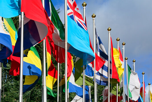 Geneva, Switzerland, Europe : Palace of Nations, national flags of the member states fluttering in the wind, European Headquarters of United Nations, United Nations Office at Geneva (UNOG)