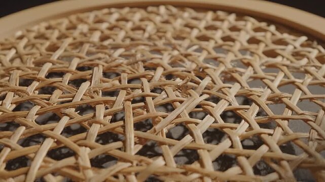 Woven cane texture close-up, highlighting the intricate natural pattern of the organic material, perfect as a rustic or craft-inspired background.