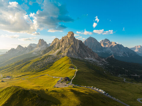 Dramatic sunset sky stretches over Passo Giau as rugged Dolomites peaks rise above alpine terrain. Strong contrast, depth, and scale define this powerful high-mountain landscape in northern Italy