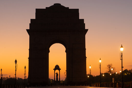 India Gate and Netaji Subhas Chandra Bose Canopy silhouette during sunrise - New Delhi, India