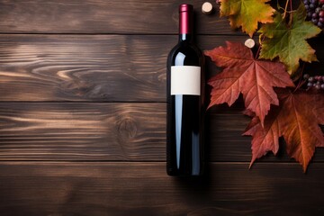 Fototapeta premium Red wine bottle with blank label, autumn leaves, and corks on a dark wooden background