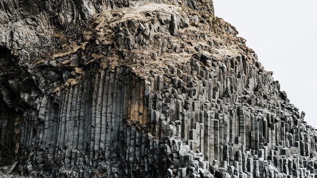 Basalt columns raising on the black beach, Reynisfjara, Iceland