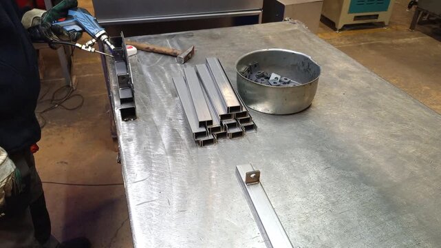Steel profiles on workbench in manufacturing workshop