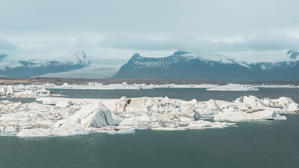 The Jokulsarlon glacier lagoon was formed naturally from melted glacial water - reminder of global warming. The ice is in various colors – transparent to deep blue,  with black streaks of volcanic ash © Micha