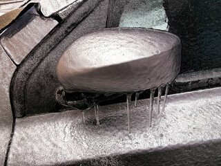 Eis und Eiszapfen an einem zugefrorenen Fahrzeug
