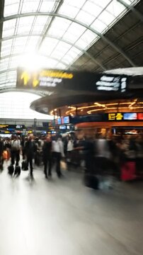 Motion blurred people walking in bright airport terminal