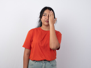 Happy pretty young asian woman orange t-shirt isolated white background. close your eyes.
