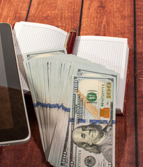 Manager's accessories: money, notebook, tablet, and pen