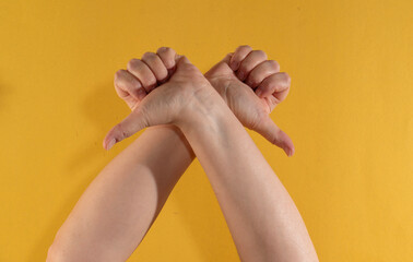 The "thumbs down" gesture. A symbol of disapproval, dissatisfaction, rejection, or negative evaluation.