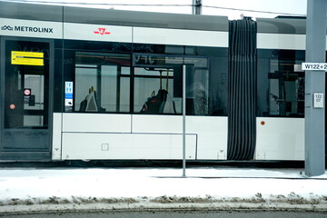 Naklejka premium Toronto, Ontario, Canada, February 6, 2026: A Metrolinx Eglinton Crosstown LRT test train makes its way along the transit line in Scarborough. This LRT line, after waiting for years to open, is now sc