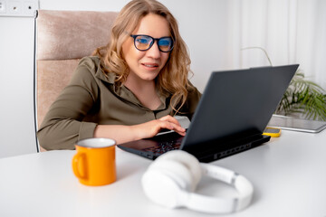 Fototapeta premium Confused woman looking at laptop screen with blue light reflection on glasses due to system error or software glitch