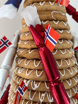 Traditional Norwegian Kransekake Wreath Cake Decorated with Norway Flags and Festive Crackers for National Day Celebration or Wedding