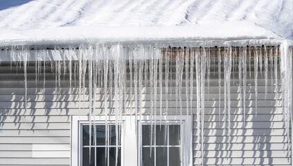 winter house with icicle and snow on the roof © nd700