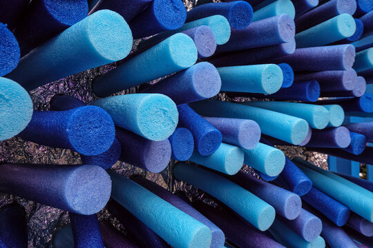 Porous thermal insulation tubes. Background with blue tones colored round sealing tapes made of closed-cell polyethylene foam.