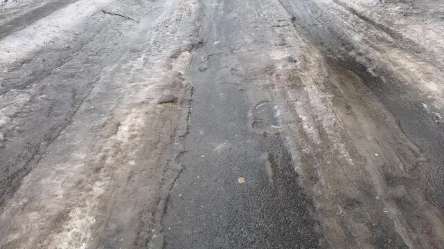 The road was covered with ice after the rain in the frost.