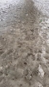 The road was covered with ice after the rain in the frost.