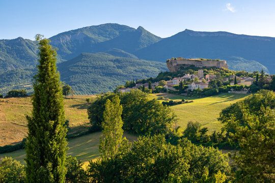 Summer view of the perched village of Mison in Alpes-de-Haute-Provence, France, surrounded by rolling countryside in the French Prealps