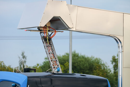 Pantograph of the electric bus at a charging station. Close-up.