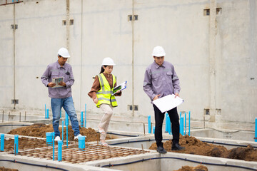 Reinforced concrete structures. Man and woman construction worker working together at workplace. Group of professional construction engineering people in hardhat safety helmet. Unity and teamwork