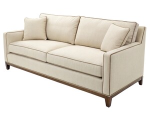 Obraz premium Elegant beige sofa with decorative pillows in a modern living room setting