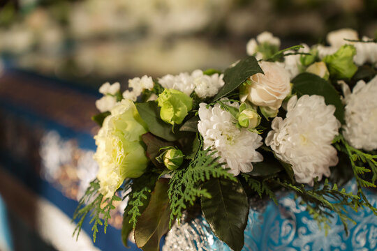 White and green flowers adorn Orthodox holiday of Assumption of the Virgin in church