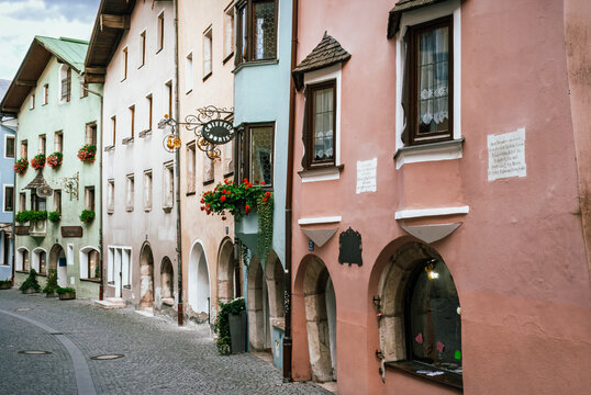 A Timeless Passageway Framed by Flowers, Arches, and Alpine Stillness