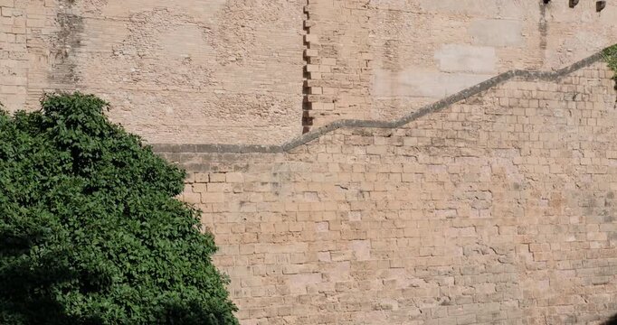 Royal Palace of Almudaina facade wall in Palma de Mallorca, Spain. Tilt shot.