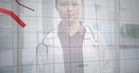 Standing doctor wearing lab coat and stethoscope, facing clinic with data grid showing red trend