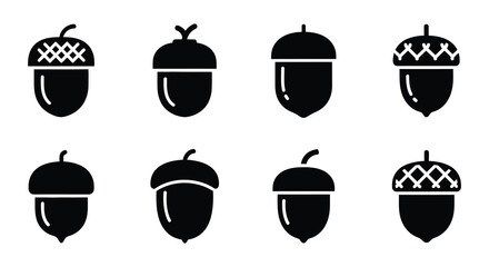 A collection of black silhouette acorns in various styles and orientations © nurjahan