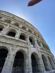 Obraz premium The Colosseum in Rome, iconic ancient Roman amphitheater, dramatic perspective, warm sunset lighting, detailed stone textures, monumental architecture, historic atmosphere, high-resolution editorial t