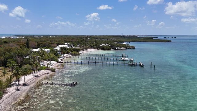 Waterfront homes with long docks along the coastline at Key Largo in the Florida Keys, United States.