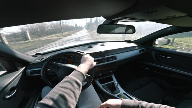 POV car turning onto road, interior driving view