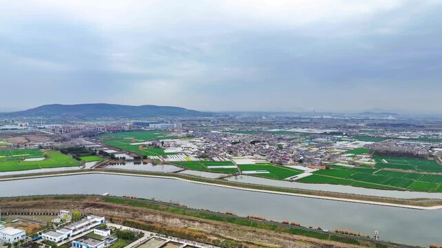 Aerial Farmland with Irrigation Channels and Mountain Landscape
