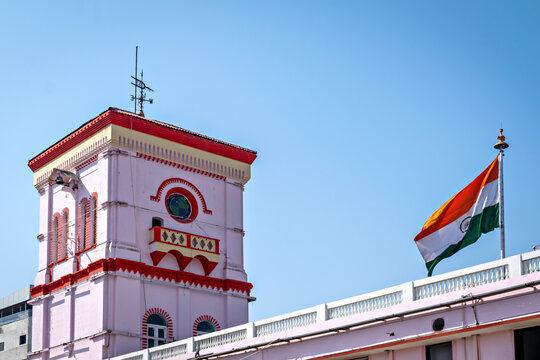Freshly painted Bharuch railway station building with Indian tricolor flag flying, Gujarat, India.